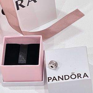 This is a Pandora Swirl Charm Clip, used in new condition